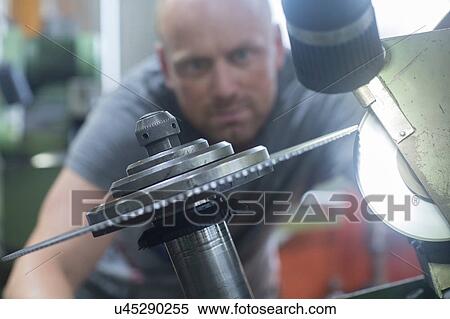 Man checking rotary blade on grinding machine View Large Photo Image Stock Photography - Man checking rotary blade on grinding machine. Fotosearch