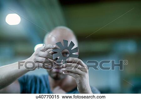 Stock Photography - Man checking rotary blade. Fotosearch