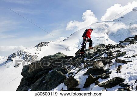 Man climbing up snow covered mountain, Saas Fee, Switzerland View Large Photo Image Stock Photo - Man climbing up snow covered mountain, Saas Fee, Switzerland. Fotosearch