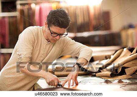 Man cutting leather with utility knife in leather jacket manufacturers View Large Photo Image Stock Image - Man cutting leather with utility knife in leather jacket manufacturers. Fotosearch