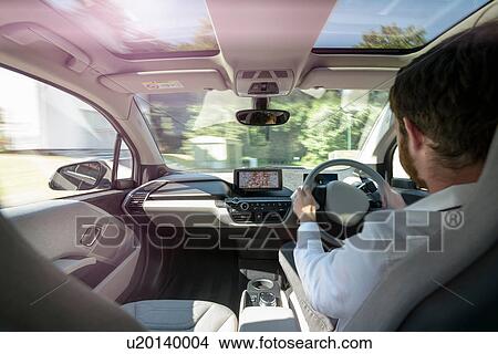Man driving electric car View Large Photo Image Picture - Man driving electric car. Fotosearch