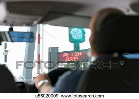 Man driving through signals at toll booth at bridge toll View Large Photo Image Stock Photo - Man driving through signals at toll booth at bridge toll. Fotosearch
