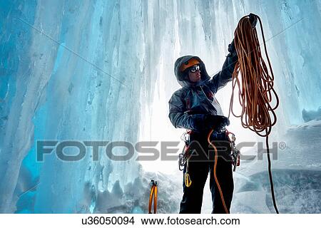 Man in ice cave preparing climbing rope, Saas Fee, Switzerland View Large Photo Image Picture - Man in ice cave preparing climbing rope, Saas Fee, Switzerland. Fotosearch
