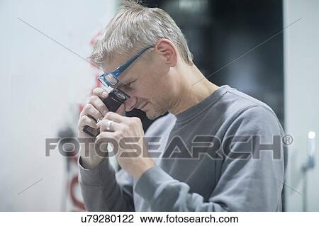 Man looking into magnifying loupe View Large Photo Image Stock Image - Man looking into magnifying loupe. Fotosearch