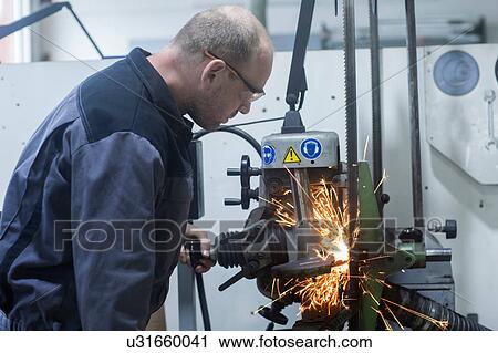 Man monitoring grinding machine in workshop View Large Photo Image Stock Image - Man monitoring grinding machine in workshop. Fotosearch