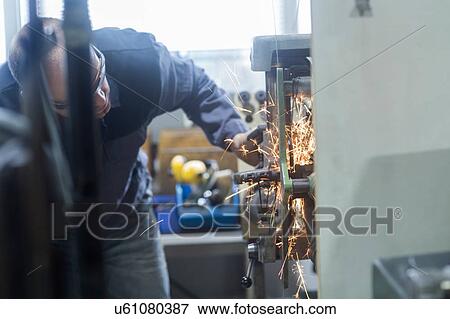 Man monitoring grinding machine in workshop View Large Photo Image Stock Photo - Man monitoring grinding machine in workshop. Fotosearch