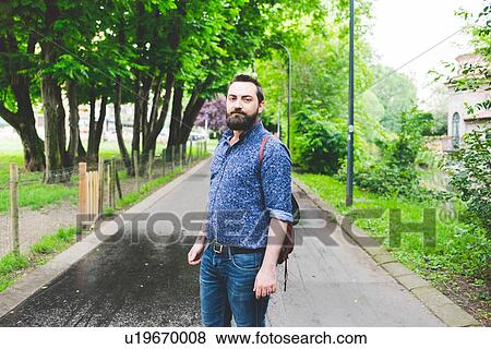 Stock Photo - Man posing in park. Fotosearch