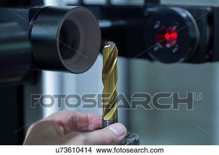 Picture - Man preparing grinding machine. Fotosearch