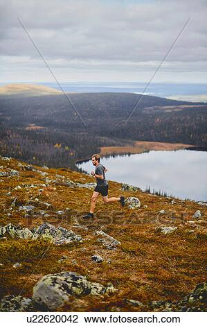 Man running on rocky cliff top, Keimiotunturi, Lapland, Finland View Large Photo Image Stock Image - Man running on rocky cliff top, Keimiotunturi, Lapland, Finland. Fotosearch
