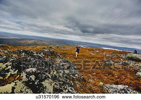 Man running on rocky cliff top, Keimiotunturi, Lapland, Finland View Large Photo Image Stock Photograph - Man running on rocky cliff top, Keimiotunturi, Lapland, Finland. Fotosearch