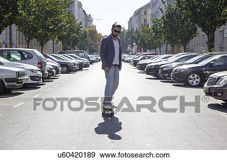 Man skateboarding in street, Berlin, Germany View Large Photo Image Stock Photo - Man skateboarding in street, Berlin, Germany. Fotosearch