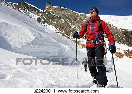Man ski touring on snow-covered mountain, Saas Fee, Switzerland View Large Photo Image Stock Image - Man ski touring on snow-covered mountain, Saas Fee, Switzerland. Fotosearch