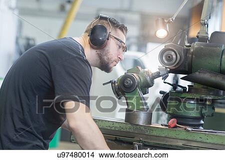 Man working in grinding workshop View Large Photo Image Picture - Man working in grinding workshop. Fotosearch