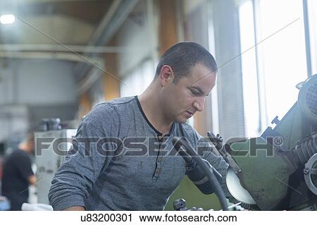 Man working in grinding workshop View Large Photo Image Stock Image - Man working in grinding workshop. Fotosearch