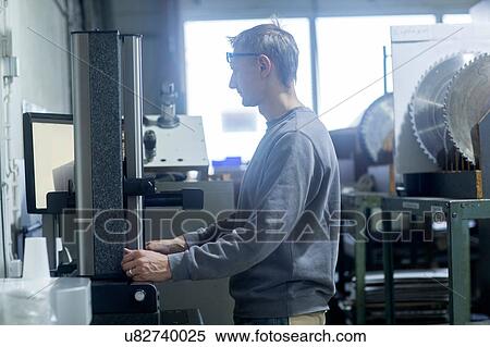 Stock Photography - Man working in grinding workshop. Fotosearch