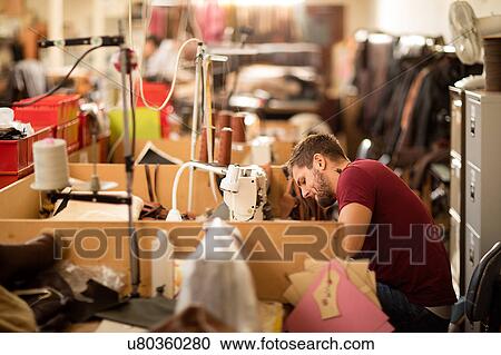 Man working in leather jacket manufacturers View Large Photo Image Stock Image - Man working in leather jacket manufacturers. Fotosearch