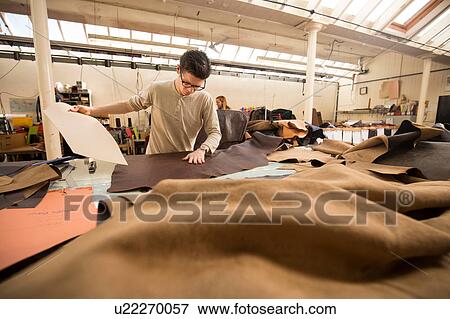 Man working in leather jacket manufacturers View Large Photo Image Stock Photo - Man working in leather jacket manufacturers. Fotosearch