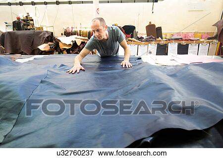 Man working in leather jacket manufacturers View Large Photo Image Stock Photo - Man working in leather jacket manufacturers. Fotosearch