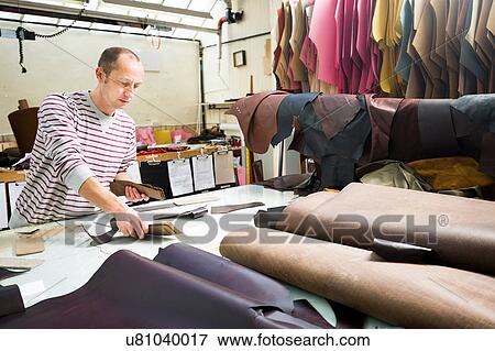 Man working in leather jacket manufacturers View Large Photo Image Stock Photo - Man working in leather jacket manufacturers. Fotosearch