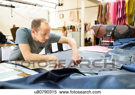 Man working in leather jacket manufacturers View Large Photo Image Stock Photography - Man working in leather jacket manufacturers. Fotosearch