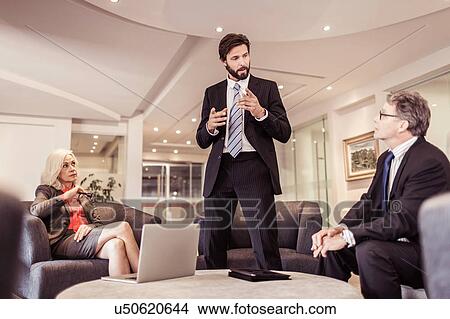 Picture - Mature businessman explaining at meeting. Fotosearch