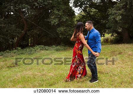 Picture - Mature couple outdoors, in field, dancing. Fotosearch