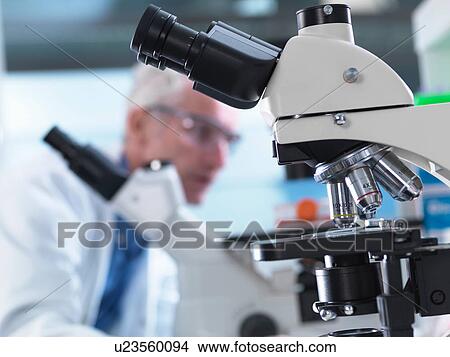 Picture - Microscopes being used during an experiment in a laboratory. Fotosearch