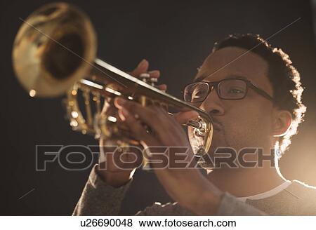 Mid adult man playing trumpet View Large Photo Image Stock Photo - Mid adult man playing trumpet. Fotosearch