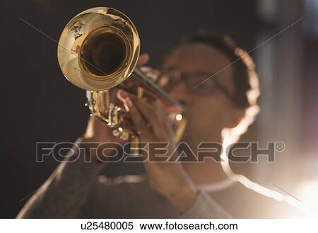Mid adult man playing trumpet View Large Photo Image Stock Photography - Mid adult man playing trumpet. Fotosearch