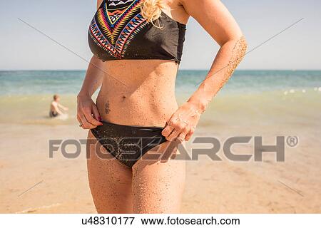 Stock Photo - Mid section of woman in bikini on beach, Altea, Alicante Province, Spain. Fotosearch