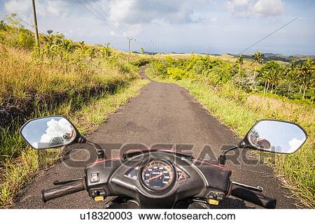 Mirror image of motorcyclist in motorcycle wing mirrors on rural road, Tanglad, Nusa Penida, Indonesia View Large Photo Image Stock Image - Mirror image of motorcyclist in motorcycle wing mirrors on rural road, Tanglad, Nusa Penida, Indonesia. Fotosearch