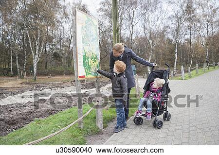 Mother and children (4-5, 8-9) looking at map in park View Large Photo Image Stock Image - Mother and children (4-5, 8-9) looking at map in park. Fotosearch