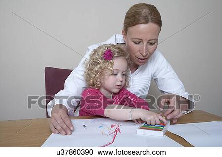 Mother and daughter (4-5) drawing with crayons View Large Photo Image Stock Image - Mother and daughter (4-5) drawing with crayons. Fotosearch