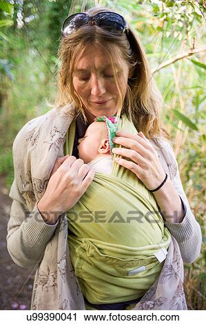 Mother carrying baby girl in sling View Large Photo Image Stock Image - Mother carrying baby girl in sling. Fotosearch