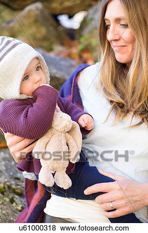 Mother holding baby girl smiling View Large Photo Image Stock Photo - Mother holding baby girl smiling. Fotosearch