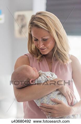 Mother holding baby son (0-1 months) View Large Photo Image Stock Image - Mother holding baby son (0-1 months). Fotosearch