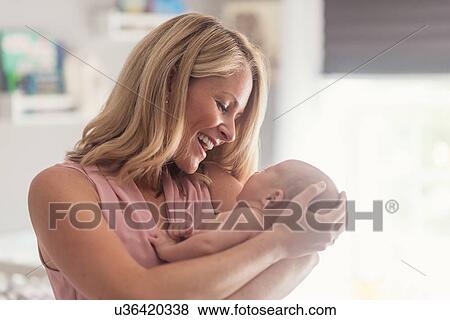 Mother holding baby son (0-1 months) View Large Photo Image Stock Photo - Mother holding baby son (0-1 months). Fotosearch