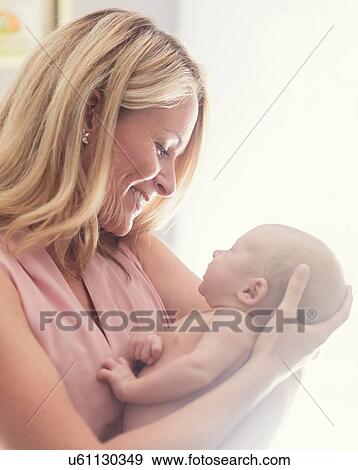 Mother holding baby son (0-1 months) View Large Photo Image Stock Photo - Mother holding baby son (0-1 months). Fotosearch