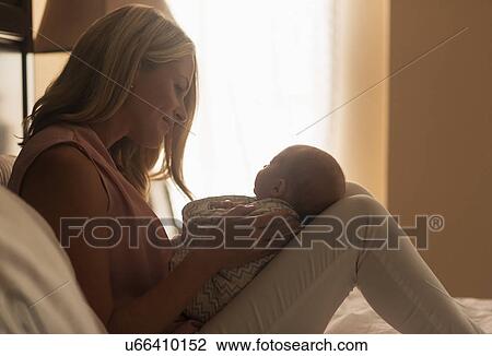 Mother holding son (0-1 months) in bedroom View Large Photo Image Stock Image - Mother holding son (0-1 months) in bedroom. Fotosearch