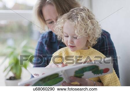 Mother reading book to daughter (4-5) View Large Photo Image Stock Image - Mother reading book to daughter (4-5). Fotosearch