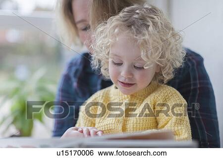 Mother reading book to daughter (4-5) View Large Photo Image Stock Photograph - Mother reading book to daughter (4-5). Fotosearch
