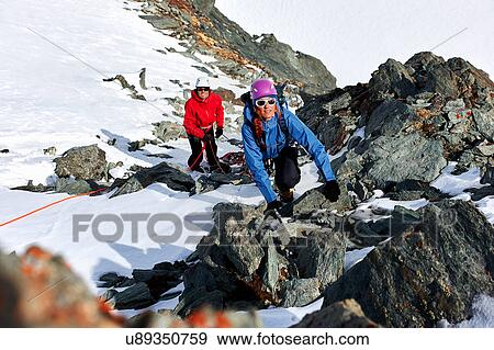 Mountaineer climbing up snow covered mountain, Saas Fee, Switzerland View Large Photo Image Stock Photo - Mountaineer climbing up snow covered mountain, Saas Fee, Switzerland. Fotosearch