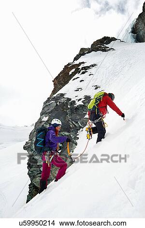 Picture - Mountaineers ascending snow-covered mountain, Saas Fee, Switzerland. Fotosearch