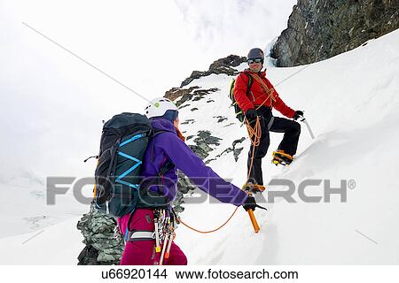 Picture - Mountaineers ascending snow-covered mountain, Saas Fee, Switzerland. Fotosearch