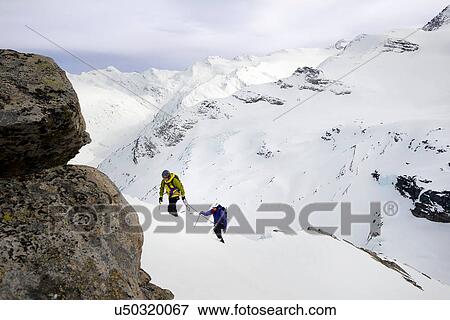 Mountaineers ascending snow-covered mountain, Saas Fee, Switzerland View Large Photo Image Stock Photo - Mountaineers ascending snow-covered mountain, Saas Fee, Switzerland. Fotosearch