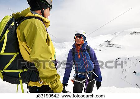Mountaineers on snow-covered mountain smiling, Saas Fee, Switzerland View Large Photo Image Stock Image - Mountaineers on snow-covered mountain smiling, Saas Fee, Switzerland. Fotosearch