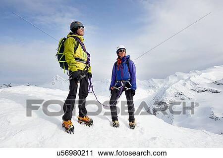 Mountaineers on top of snow-covered mountain looking away, Saas Fee, Switzerland View Large Photo Image Stock Image - Mountaineers on top of snow-covered mountain looking away, Saas Fee, Switzerland. Fotosearch