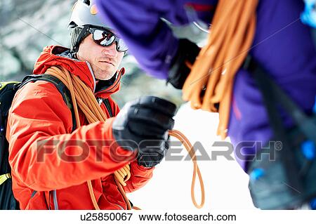 Mountaineers preparing climbing equipment View Large Photo Image Stock Photo - Mountaineers preparing climbing equipment. Fotosearch