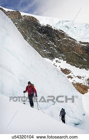 Mountaineers ski touring on snow-covered mountain, Saas Fee, Switzerland View Large Photo Image Picture - Mountaineers ski touring on snow-covered mountain, Saas Fee, Switzerland. Fotosearch