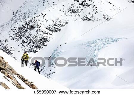 Mountaineers ski touring on snow-covered mountain, Saas Fee, Switzerland View Large Photo Image Stock Photo - Mountaineers ski touring on snow-covered mountain, Saas Fee, Switzerland. Fotosearch